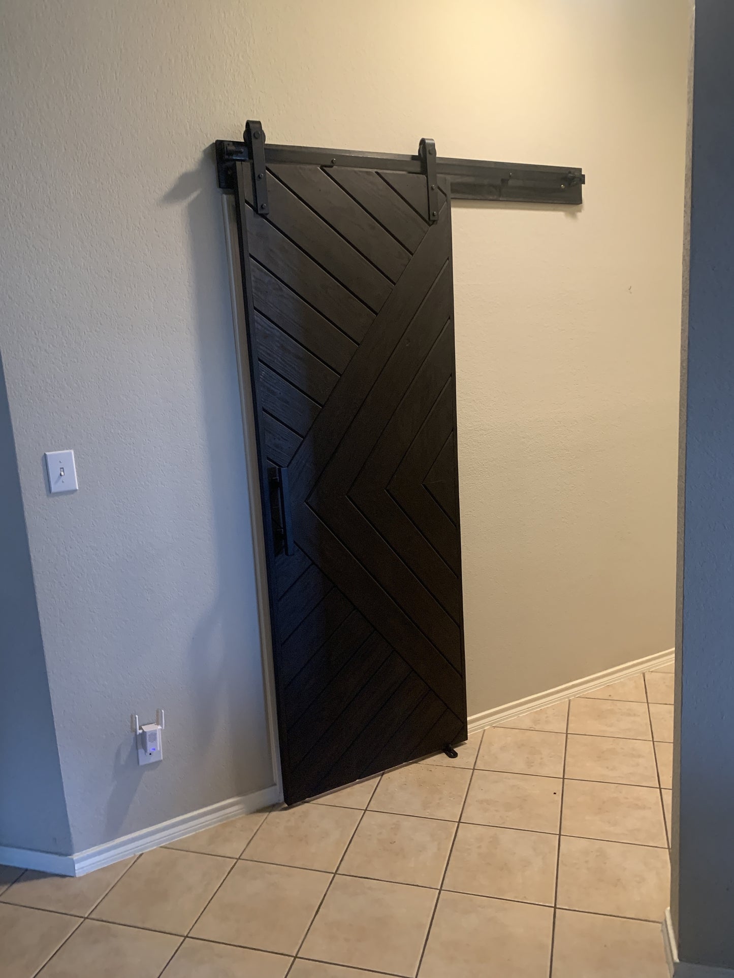Dark Chevron Pattern Barn Door with Black Hardware