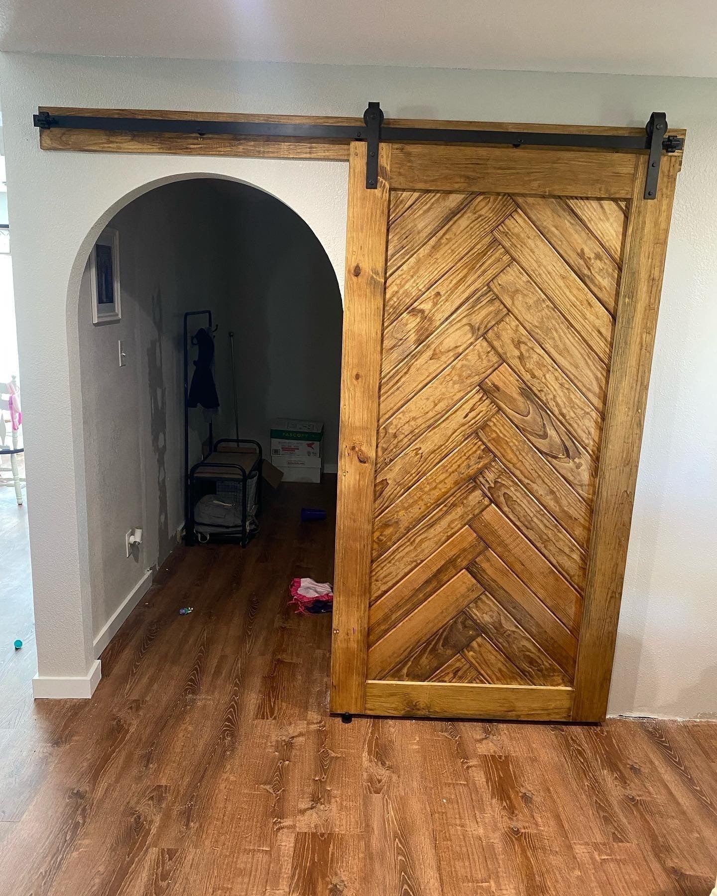 Chevron Pattern Sliding Barn Door with Dark Hardware